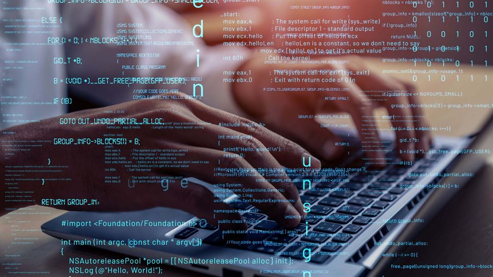 Hands typing on a laptop beneath layers of code